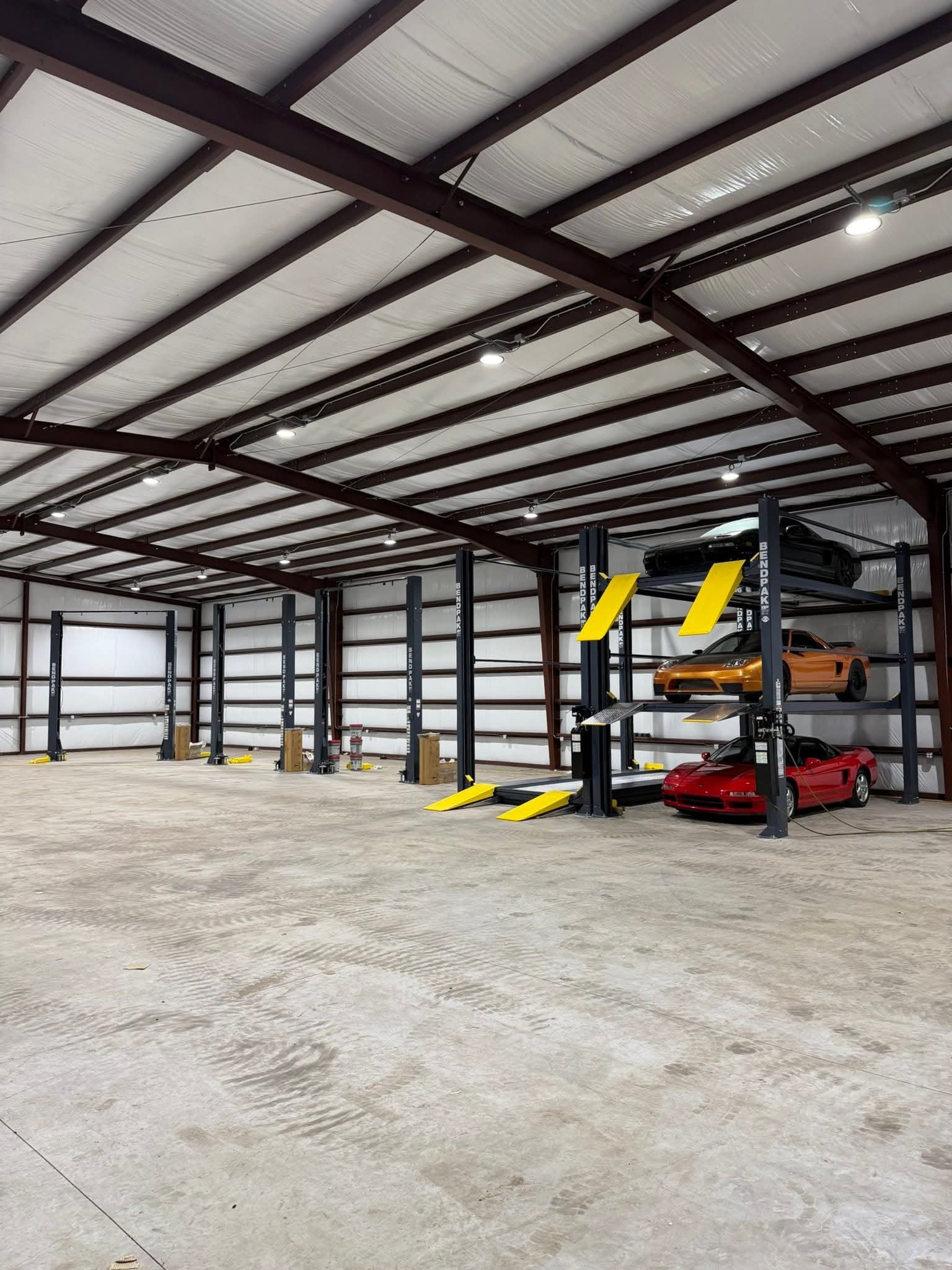 Three-tier vehicle storage system with cars on elevated platforms